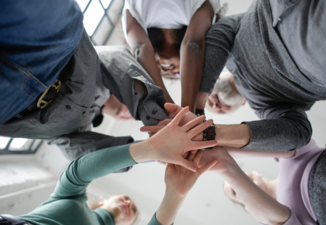 Group of people in a circle holding hands